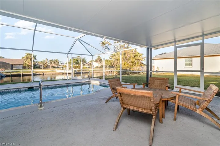 View of pool with a water view, a lanai, and a patio area