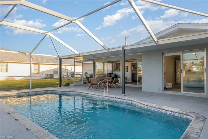 View of pool with a lanai and a patio area
