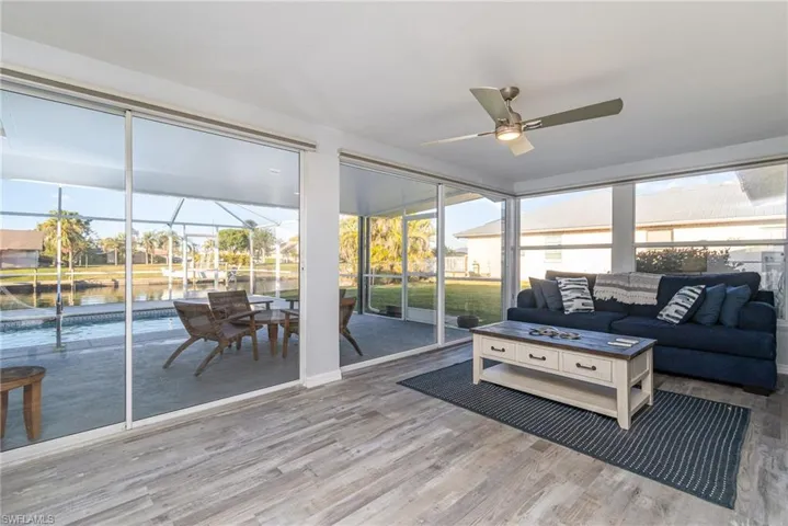Sunroom with a water view and ceiling fan