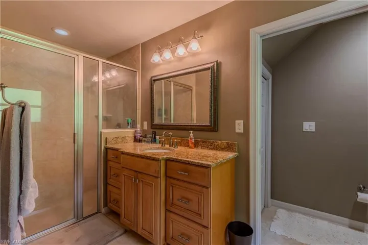 Full bathroom with vanity and a stall shower