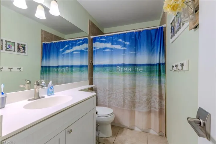 Bathroom featuring tile patterned floors and vanity