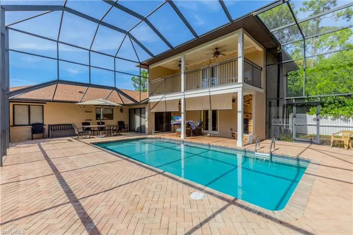 Back of house with a patio, ceiling fan, stucco siding, a lanai, and a balcony