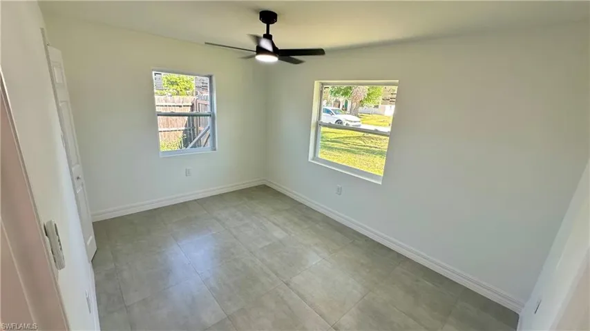 Empty room with baseboards and ceiling fan