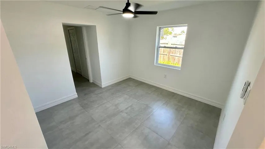 Unfurnished room featuring baseboards and a ceiling fan