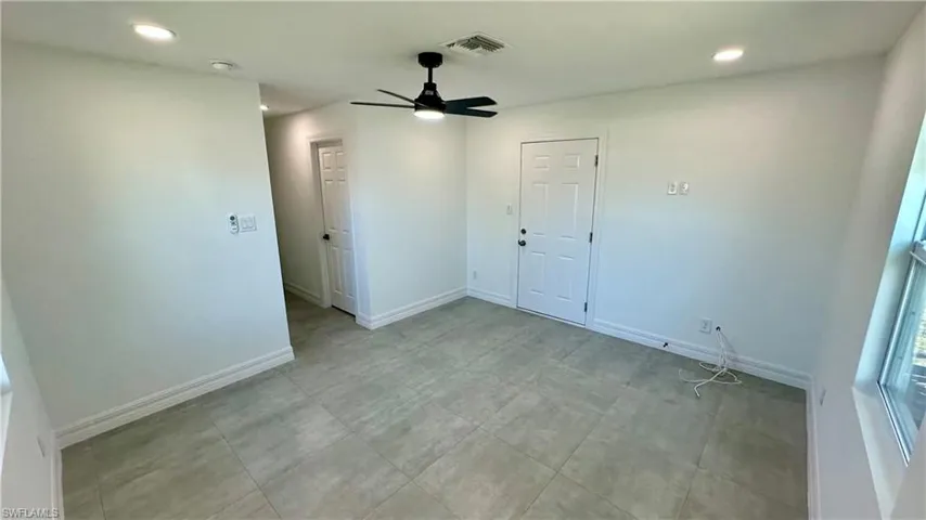 Unfurnished room featuring baseboards, ceiling fan, visible vents, and recessed lighting