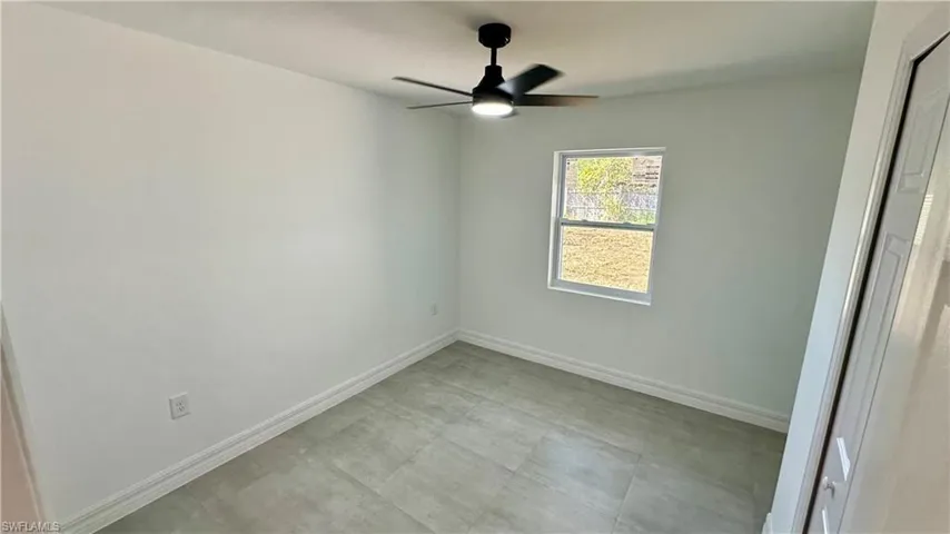 Unfurnished bedroom with a ceiling fan and baseboards