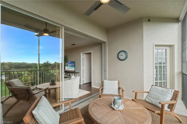 Balcony with eastern exposure, screened lanai, golf course and lake views, tile flooring, built-in cabinetry and electric grill (not shown).