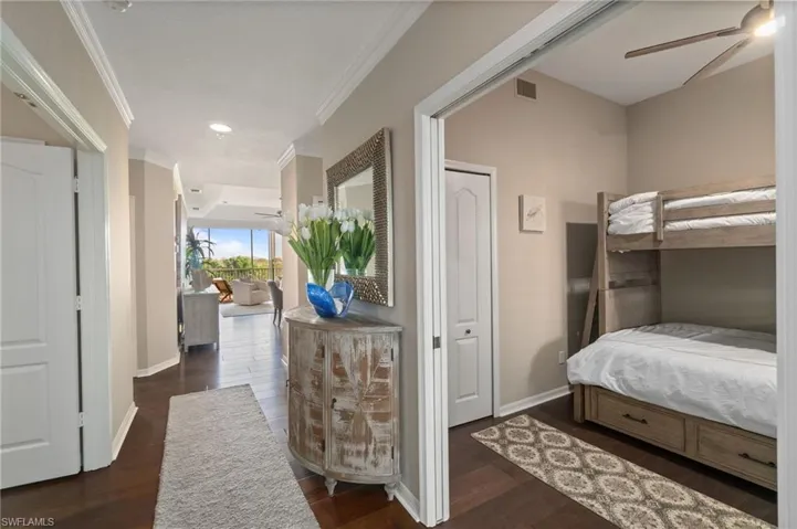 Foyer featuring custom lighting, crown molding and wood floors, access to the 3rd bedroom.