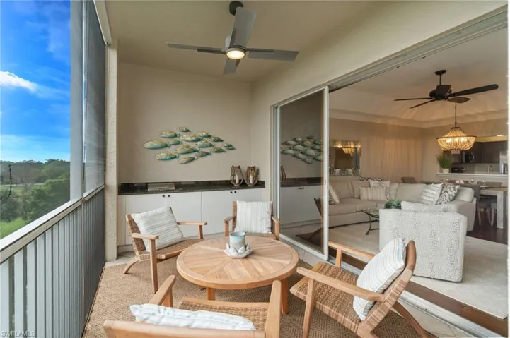 Balcony with eastern exposure, screened lanai, golf course and lake views, tile flooring, built-in cabinetry and electric grill.