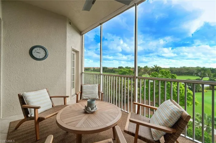 Balcony with eastern exposure, screened lanai, golf course and lake views, tile flooring, built-in cabinetry and electric grill (not shown)