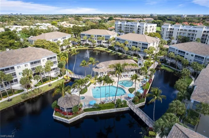 Aerial view of Pebble Creek scenic amenity island with two pools, spa, fitness center, sauna, clubhouse and professional on-site management.