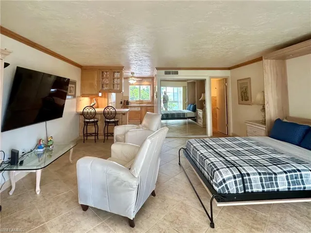 Open and bright space. 18” tile on the diagonal and Crown molding throughout. Turnkey furnished