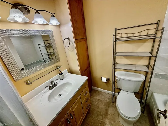 Bathroom with tile patterned floors, vanity, and toilet
