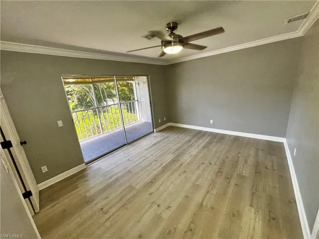 Spare room with crown molding, ceiling fan, and light hardwood / wood-style flooring