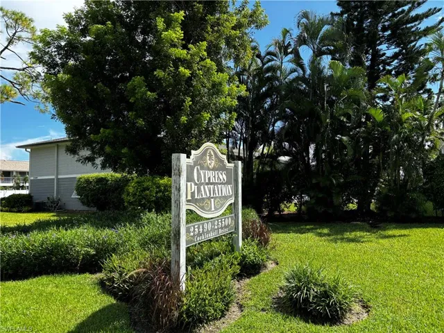 Community / neighborhood sign with a lawn