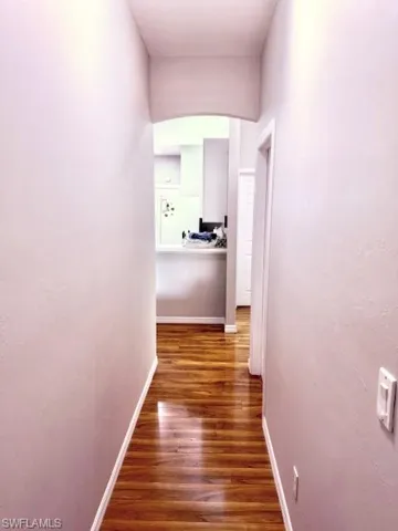 Corridor featuring dark hardwood / wood-style floors