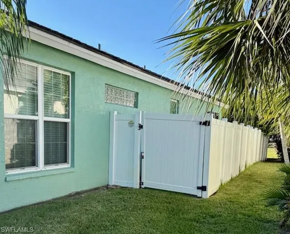 View of side of property featuring a lawn