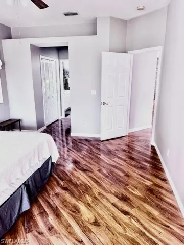 Bedroom featuring hardwood / wood-style floors, a closet, and ceiling fan
