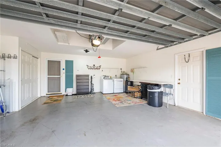 Large garage, screen door, storage cabinets, washer, dryer, door out