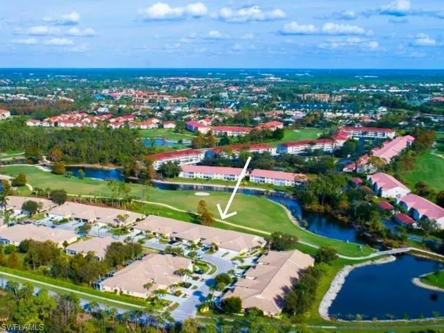 Birds eye view of property with a water view