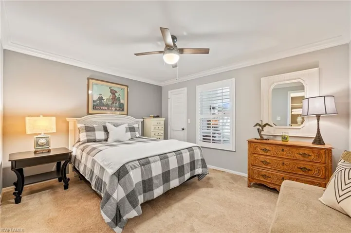 Spacious guest bedroom. Plantation shutters