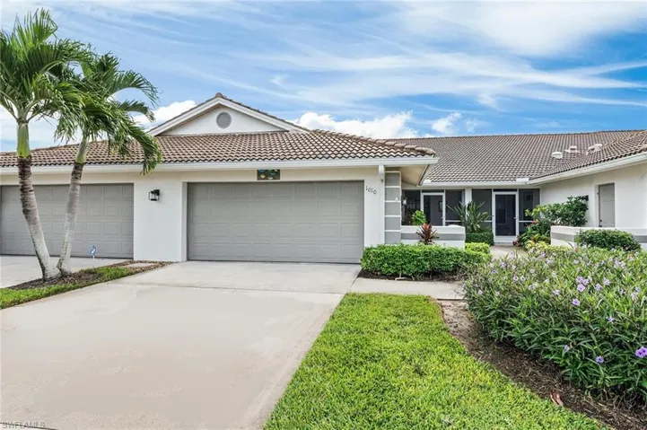 Home front with 2 car garage and courtyard to front lanai entry