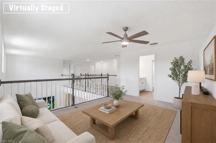 Upper-level living space with carpeted flooring and white walls