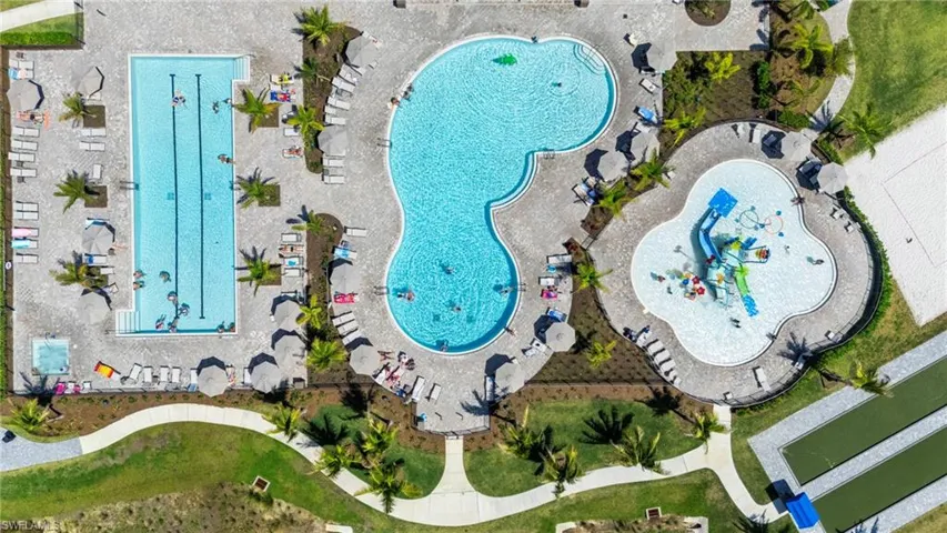 Expansive aquatic center featuring a multi-lane lap pool, a free-form leisure pool, and a splash pad with water features