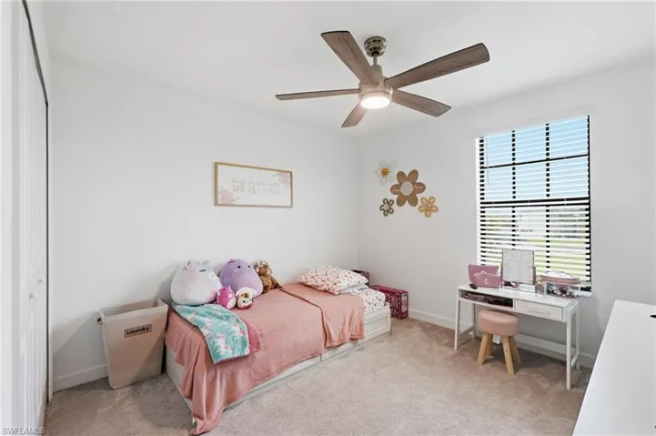 Second Floor- Bedroom featuring light-toned carpeting, a ceiling fan with integrated lighting, and a window with horizontal blinds
