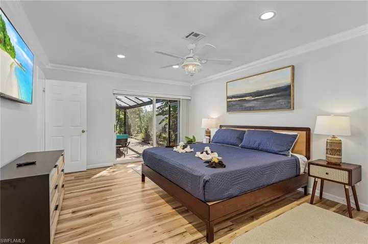 Master bedroom with sliding glass doors out to the pool.