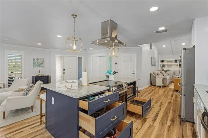 The well lit kitchen with stylish fixtures and hardware create a relaxing environment.