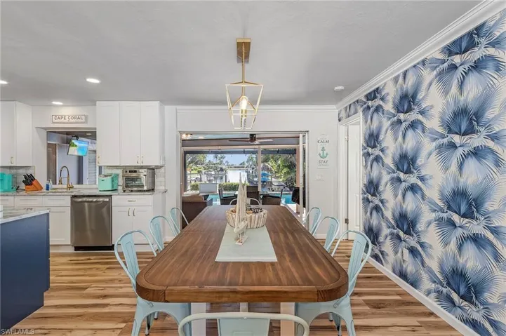 Plenty of space for dining.  Blue palm leaf custom wall design creates the perfect tropical vibe.