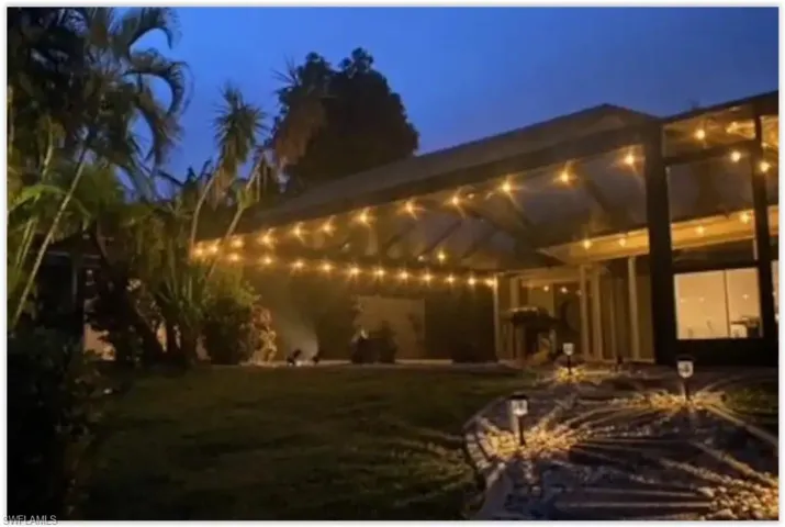 The entire perimeter of the pool and lanai is lined with cafe lights.