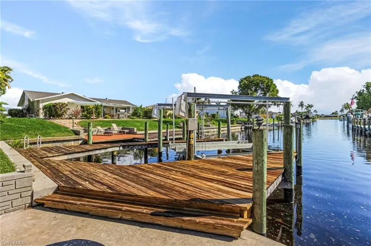 12,500 pound boat lift with dock on saltwater gulf access canal just 15 minutes to the open river water.