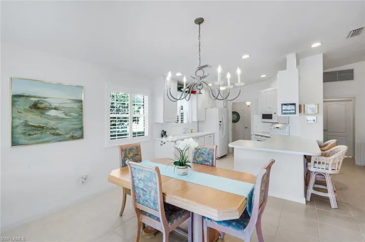Dining room featuring a chandelier, recessed lighting, and lofted ceiling