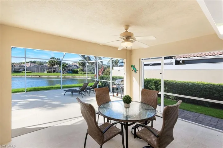 Covered lanai with outstanding lake view,  a ceiling fan, and plenty of natural light.  Electric Storm shutter protection along the slider.
