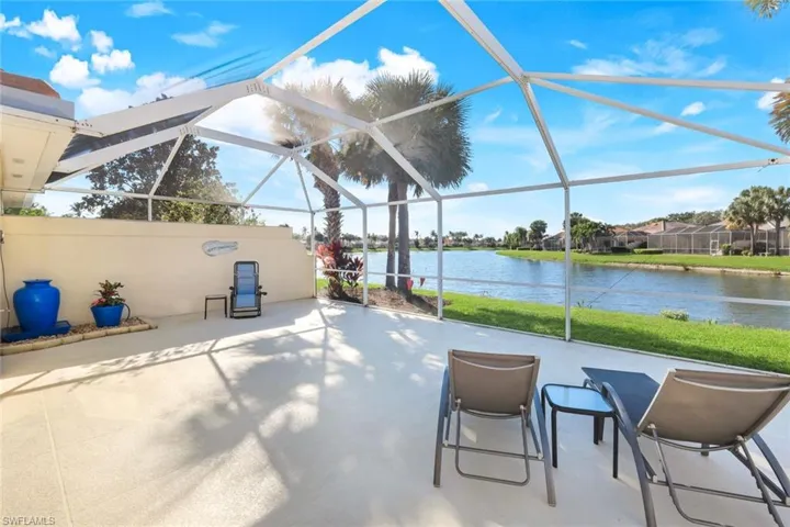 View of lanai with beautiful western lake view and peaceful water feature.