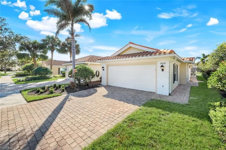 Mediterranean / spanish house featuring stucco siding, decorative driveway, an attached 2 car garage, and a tiled roof