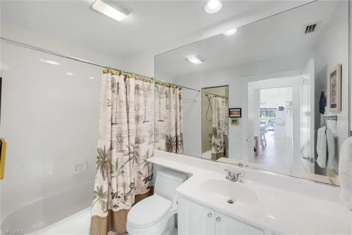 Bathroom with shower / tub combo with comfort height toilet.
