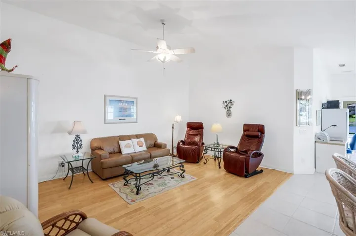 Living area featuring light wood-type flooring and a ceiling fan