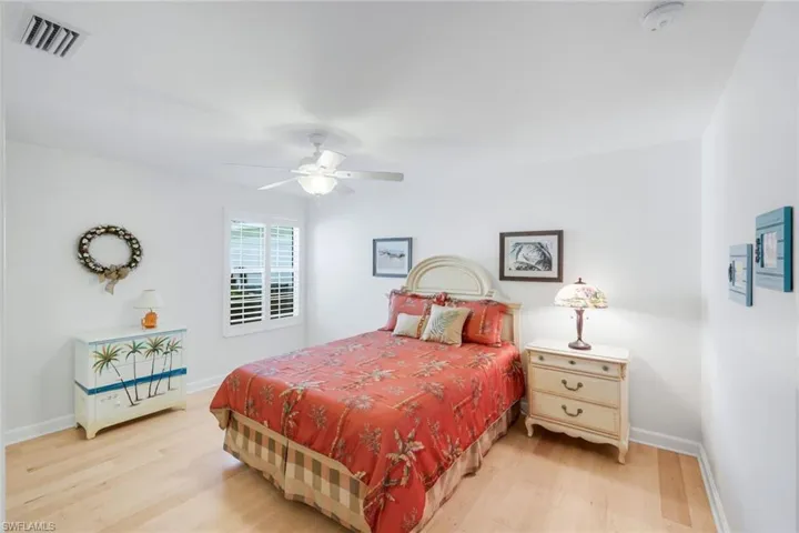 Bedroom with light wood-style floors and ceiling fan