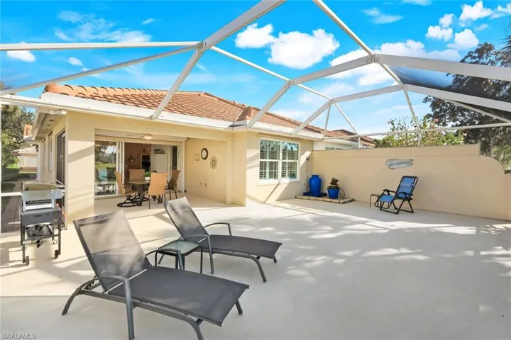 View of patio / terrace featuring screened enclosure,  a grill, and outdoor dining space