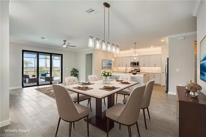 Dining space with ornamental molding, baseboards, recessed lighting, and a ceiling fan