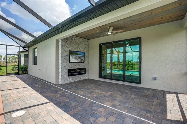View of patio / terrace with ceiling fan and a lanai