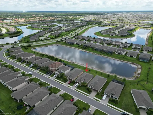 Aerial perspective highlighting a residential community with water features