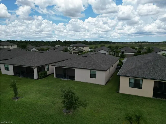 Residential neighborhood featuring a series of single-story homes with neutral stucco exteriors and dark shingle roofs