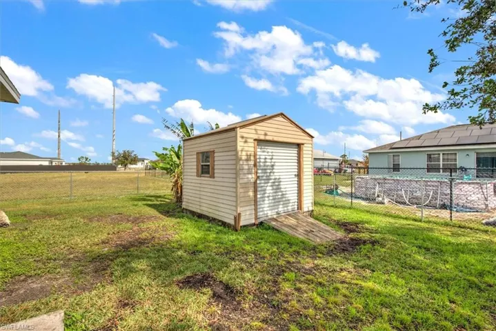 View of outdoor Shed with a yard