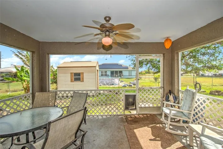 Sunroom with a wealth of natural light and ceiling fan