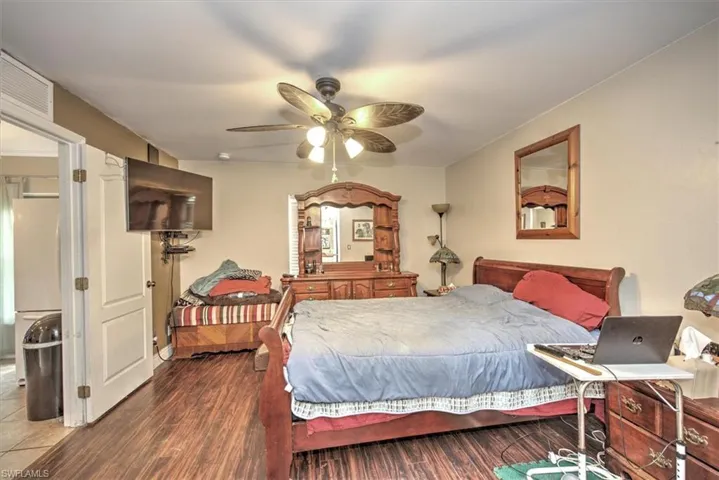 Bedroom with dark wood-type flooring and ceiling fan