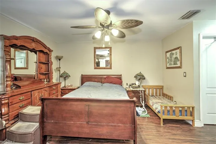 Bedroom featuring hardwood / wood-style floors and ceiling fan